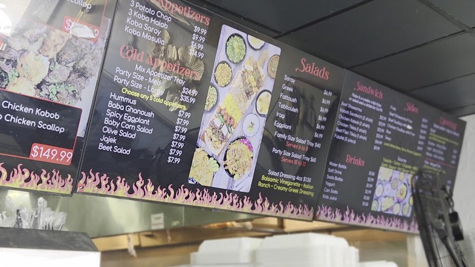 Printed menu featuring hummus, fattoush, and kabob plates.